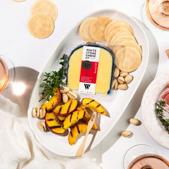 Retail pack of Round Hill with grilled peaches, pistatchios and wafer crackers