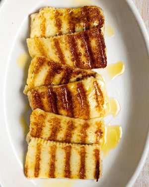 Cooked slices of Whitestone Ferry Rd Halloumi cooked with a drizzle of honey