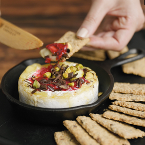 Baked Mt Domett Double Cream Brie topped with pistachios, raspberries and chocolate